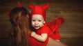 Family mother and baby son celebrate Halloween in devil costume Royalty Free Stock Photo