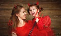 Family mother and child daughter celebrate Halloween in devil co Royalty Free Stock Photo