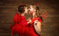 Family mother and child daughter celebrate Halloween in devil co Royalty Free Stock Photo