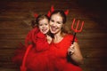 Family mother and child daughter celebrate Halloween in devil co Royalty Free Stock Photo