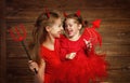 Family mother and child daughter celebrate Halloween in devil co Royalty Free Stock Photo