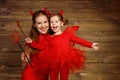 Family mother and child daughter celebrate Halloween in devil co Royalty Free Stock Photo