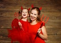 Family mother and child daughter celebrate Halloween in devil co Royalty Free Stock Photo