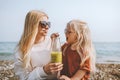 Family mother and child daughter drinking vegan smoothie travel outdoor summer beach vacations Royalty Free Stock Photo