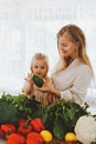 Family mother and child girl cooking vegan food together organic vegetables healthy eating sustainable lifestyle Royalty Free Stock Photo