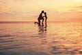 Family. Mother And Child Silhouettes. Mom And Daughter Bonding Hands On Sea Beach. Beautiful Sunset Sky And People Reflection. Royalty Free Stock Photo