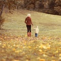 Family mother and child walking together in autumn park Royalty Free Stock Photo