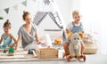 Family mother and children play a toy railway in playroom Royalty Free Stock Photo