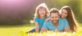 Family of mother dad and son child relax in summer park. Banner of Happy family Lying on grass. Young mother and father Royalty Free Stock Photo