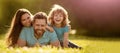 Family of mother dad and son child relax in summer park. Banner of Happy family Lying on grass. Young mother and father Royalty Free Stock Photo