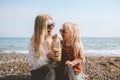 Family mother and daughter child drinking smoothie on beach healthy lifestyle Royalty Free Stock Photo