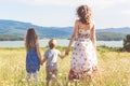 Family: mother, daughter and son in chamomile field Royalty Free Stock Photo