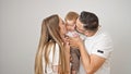 Family of mother, father and baby smiling together over isolated white background Royalty Free Stock Photo