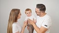 Family of mother, father and baby smiling together over isolated white background Royalty Free Stock Photo