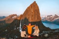 Family mother and father with child traveling together in Norway camping in mountains adventure vacations