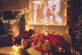 Family mother father and children watching projector, TV, movies with popcorn in   christmas evening   at home Royalty Free Stock Photo