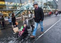 Family Mother and father and daugter in baby-stroller walking near Monparnasse Gare