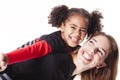 A family mother with girl child posing on a white background studio