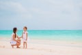 Beautiful mother and daughter at Caribbean beach enjoying summer vacation. Royalty Free Stock Photo