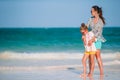 Beautiful mother and daughter at Caribbean beach enjoying summer vacation. Royalty Free Stock Photo