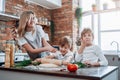 Family of mother and her two sons in kitchen they cook together Royalty Free Stock Photo