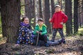 Family with mother and two children boy sibling brothers sits in