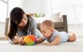 Mother and baby son playing with ball at home Royalty Free Stock Photo