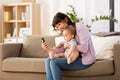 Asian mother with baby son taking selfie at home Royalty Free Stock Photo