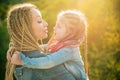 Family and motherhood concept. Mother and child girl playing kissing and hugging. Little daughter hugging her happy Royalty Free Stock Photo