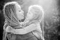 Family and motherhood concept. Mother and child girl playing kissing and hugging. Little daughter hugging her happy Royalty Free Stock Photo