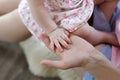 Family, motherhood, parenting, people and child care concept - close up of mother and newborn baby hands Royalty Free Stock Photo