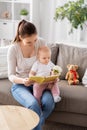 happy mother reading book to little baby at home Royalty Free Stock Photo