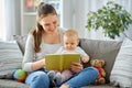 happy mother reading book to little baby at home Royalty Free Stock Photo