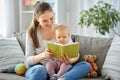 happy mother reading book to little baby at home Royalty Free Stock Photo