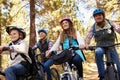 Family mountain biking in a forest, low angle front view Royalty Free Stock Photo