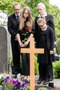 Family mourning at grave on cemetery Royalty Free Stock Photo