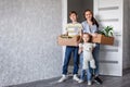 The family moves into a new apartment, a little girl runs in the door, holding cardboard boxes in the background. Mother