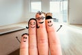 Family moving into a new home concept: Painted finger family in front of blurry bright room