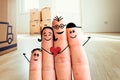 Family moving into a new home concept: Painted finger family in front of blurry bright room