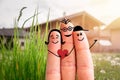 Family moving into a new home concept: Painted finger family in front of a blurry house Royalty Free Stock Photo