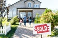 family moving into new house with sold signboard Royalty Free Stock Photo