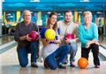 Family with multi colored bowling ball posing Royalty Free Stock Photo