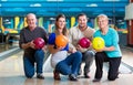 Family with multi colored bowling ball posing Royalty Free Stock Photo