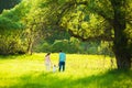 Family of mum, dad and little daughter walking together in beaut Royalty Free Stock Photo