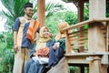 family muslim sitting in the garden and having a conversation