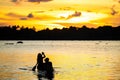 Family of native indigenous Orinoco tribe in traditional wooden canoe Royalty Free Stock Photo