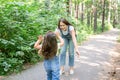 Family and nature concept - Attractive young woman have fun with her little daughter in the park Royalty Free Stock Photo