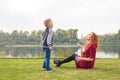 Family and nature concept - Mother and her child playing with colorful soap bubbles Royalty Free Stock Photo