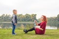 Family and nature concept - Mother and her child playing with colorful soap bubbles Royalty Free Stock Photo