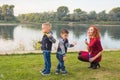 Family and nature concept - Mother and their children playing with colorful soap bubbles Royalty Free Stock Photo